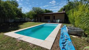 a swimming pool in the yard of a house at Finca con pileta Lasmaria in Santiago del Estero