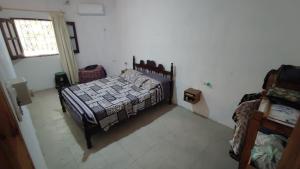 a bedroom with a bed and a window in it at Finca con pileta Lasmaria in Santiago del Estero