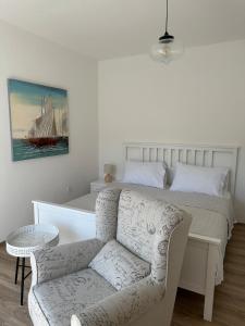 a bedroom with a bed and a chair and a couch at Holiday House Jagoda -First Row to the Sea Brbinj in Brbinj +34 photos