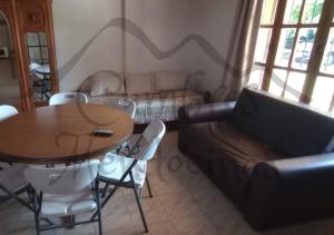 a living room with a table and a couch at Hospedaje Cumbres Mendocinas-Depto Aconcagua in San Rafael