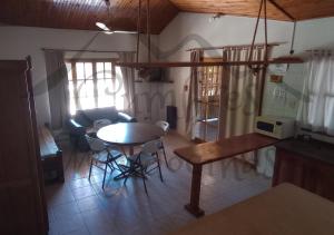 a kitchen and living room with a table and chairs at Hospedaje Cumbres Mendocinas-Depto Aconcagua in San Rafael