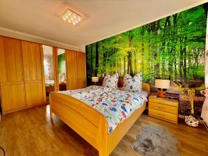 a bedroom with a bed with a painting on the wall at Ferienhaus am Kaufunger Wald in Kaufungen