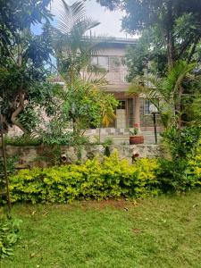 a house with trees and plants in front of it at Bonkate homes in Ongata Rongai 