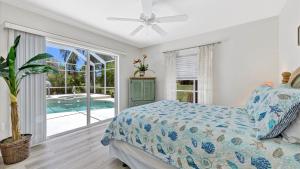a bedroom with a bed and a swimming pool at RTC974 in Rotonda West +25 photos