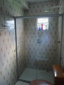 a shower with a glass door in a bathroom at casa OLINDA in Salvador +3 photos