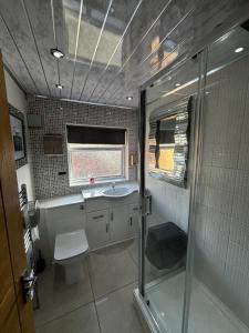 a bathroom with a shower and a sink and a toilet at Hendham House in Manchester +56 photos