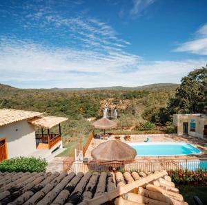 an image of a villa with a swimming pool at Pousada Cachoeira Poço Encantado in Alto Paraíso de Goiás