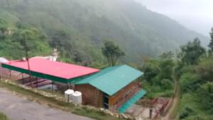a small building with a red and blue roof at El Pino De Ringlana in Lansdowne