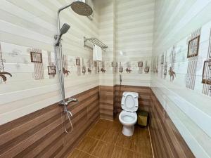 a bathroom with a shower and a toilet at Nhat Quynh Hotel in Da Lat +9 photos