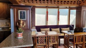 a kitchen with a table and chairs in a room at Tara Homestay in Darjeeling +26 photos