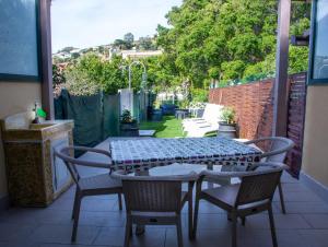 a patio with a table and chairs on a patio at La casa tra i laghi in Messina