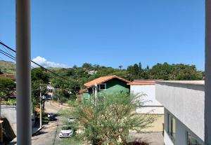a view of a street with a green house at Ap da Serra em Barão de Javary in Miguel Pereira