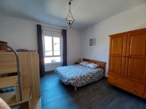 a bedroom with a bed and a dresser and a window at Cosy T3 spacieux in Aubin
