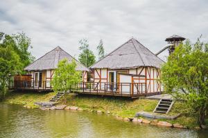 two houses on the side of a river at Slovácký dvůr s.r.o. in Ostrožská Nová Ves