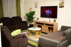 TV a/nebo společenská místnost v ubytování Lyon's Place + 1 fotografie