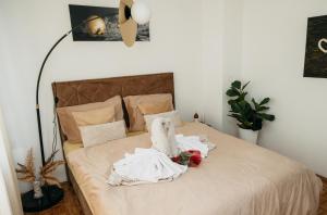 a bedroom with a bed with towels on it at DolceVita in Vinkovci