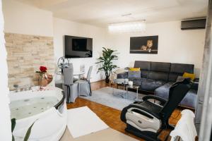 a living room with a bath tub and a couch at DolceVita in Vinkovci