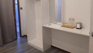 a bathroom with a counter with two bottles and a mirror at Island Grand Maldives in Hangnaameedhoo