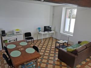 a living room with a table and a couch at LPE Maison Gite proche Illiers Combray in Magny
