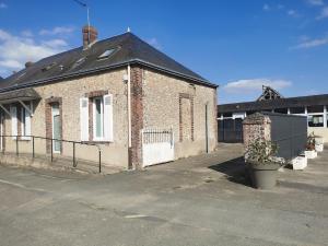 an old brick building with a black roof at LPE Maison Gite proche Illiers Combray in Magny