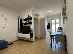 a living room with a table and a dining room at Incanto in Sestu