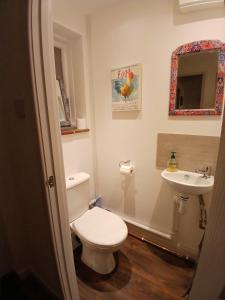 a bathroom with a toilet and a sink at Down by the Riverside in Blandford Forum +15 photos