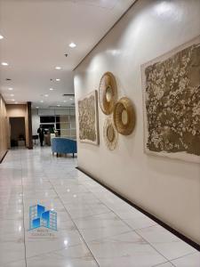 a hallway with paintings on the wall in a building at Studio and 1 Bedroom Unit at Riri's Condotel, The Loop Tower in Cagayan de Oro