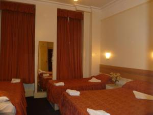 Ένα ή περισσότερα κρεβάτια σε δωμάτιο στο Grenville House Hotel +16 φωτογραφίες