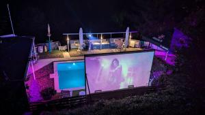 a large screen with a woman on it at night at Apartment STONE in Visoko