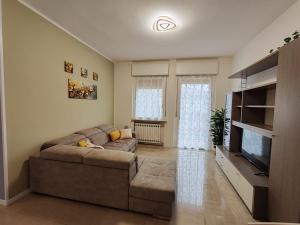 a living room with a couch and a flat screen tv at Appartamento a Legnago di "Corte San Tomaso" in Legnago