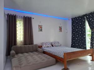 a bedroom with a bed and a couch in it at Remy's Eco house in Hernani