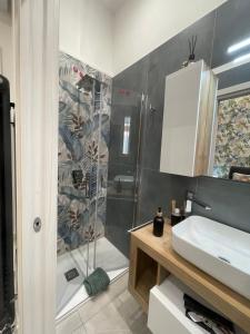 a bathroom with a shower and a sink at Nigalù House in Naples
