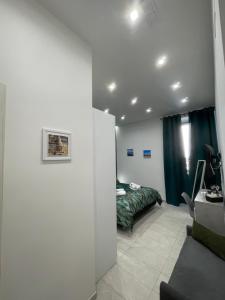 a room with a couch and a bed in it at Nigalù House in Naples