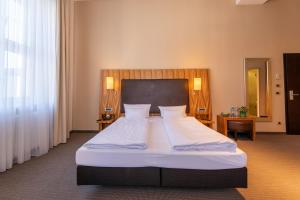 Postel nebo postele na pokoji v ubytování Herzogshof - Boutique-Hotel am Dom