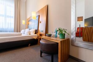 Postel nebo postele na pokoji v ubytování Herzogshof - Boutique-Hotel am Dom