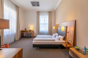 Postel nebo postele na pokoji v ubytování Herzogshof - Boutique-Hotel am Dom