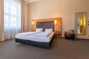 Postel nebo postele na pokoji v ubytování Herzogshof - Boutique-Hotel am Dom
