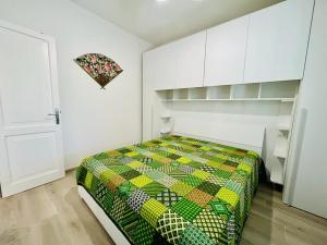 una camera con un letto con una trapunta colorata di Residence Oasi La Cinta Centro a San Teodoro