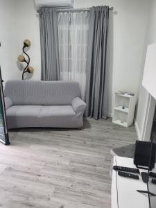 a living room with a couch and a table at Casa Pereira 1 in Ponta do Pargo +6 photos
