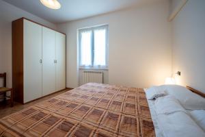 a bedroom with a large bed and a window at My Holidays New Eden Mansarda in Domaso