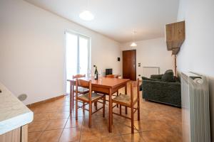 a kitchen and dining room with a table and chairs at My Holidays New Eden Mansarda in Domaso