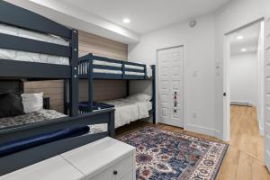a bedroom with two bunk beds and a rug at Flatrock Ocean View Sauna 3B 35BA in Flat Rock