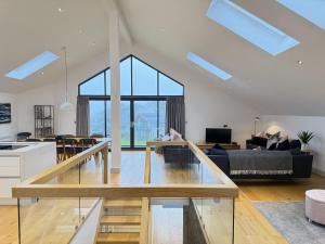 a living room and kitchen with a glass table at Fishers View, Castle Approach, Tregenna Castle in St Ives
