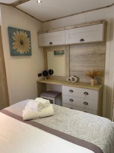 1 dormitorio con cama, escritorio y espejo en Summer Days at Seven Bays Padstow, en Padstow