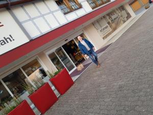 a man is standing outside of a store at Museum Lust auf Zuhause Ferien in der Provinz in Herford