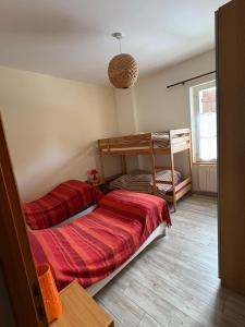 a bedroom with two bunk beds in a room at le Gite de la Bergerie in Amboise