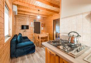 a kitchen with a stove with a tea kettle on it at Na Równej Bieszczady in Polańczyk