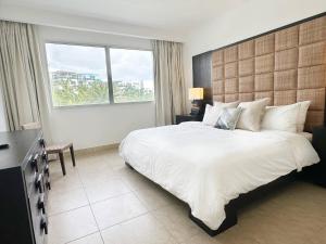 a bedroom with a large bed and a large window at Beach Apartment At Nikki Residences 2 Bedroom in El Chirú +42 photos