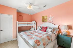 a bedroom with pink walls and a bunk bed at Sconset South 4BR Beach Escape! Deck, Bar, Games & Gulf Views in Port Bolivar