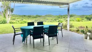 a blue table and chairs on a patio at St Lucia Holiday Cottage in St Lucia